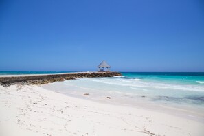 A beach with a small gazebo-like structure on a rocky outcrop. - Windjammer, 4BR by Jamaican Treasures (Boscobel)
