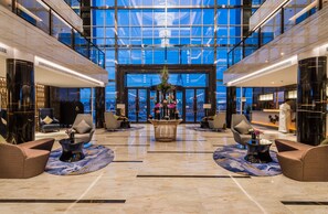 A spacious lobby with a high ceiling, large windows, and modern furnishings. - Braira Qurtubah Riyadh (Riyadh)