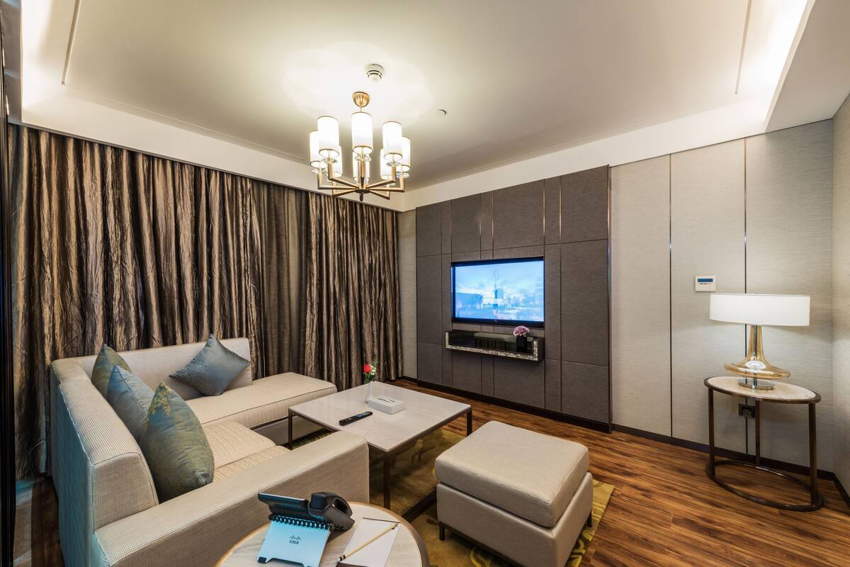 A modern living room with a sofa, coffee table, and TV.