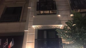 A multi-story building with illuminated windows and balconies. - Abam Hotel (Istanbul)
