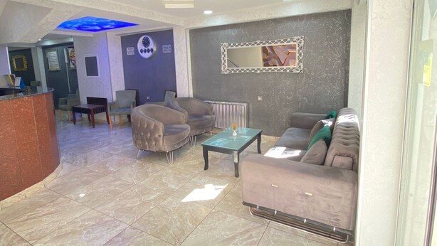 A spacious lobby with a reception desk, seating area with sofas and armchairs, a decorative mirror, and a ceiling with recessed lighting. - Abam Hotel (Istanbul)