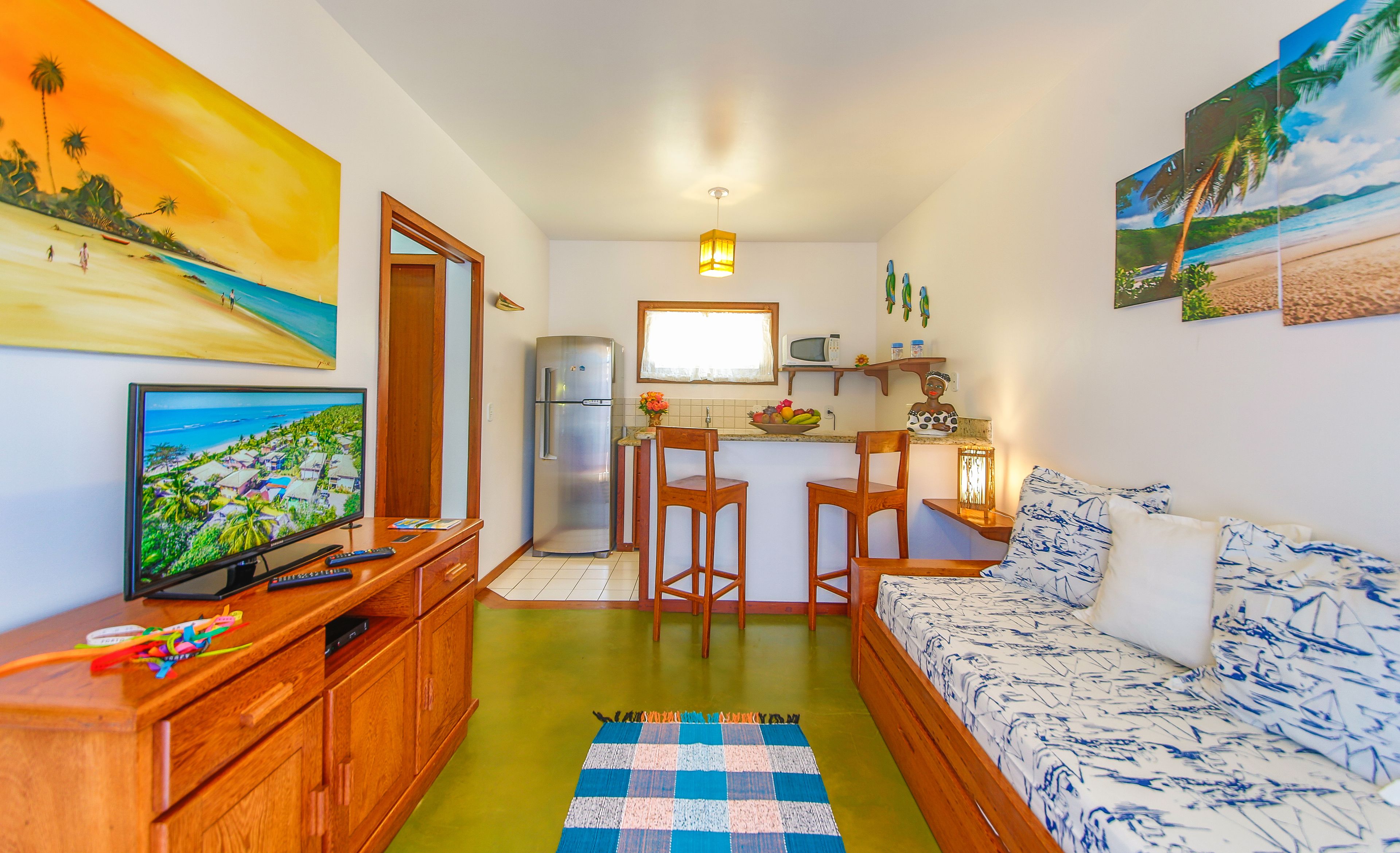 A compact living space with a kitchenette, a dining area, and a sofa.