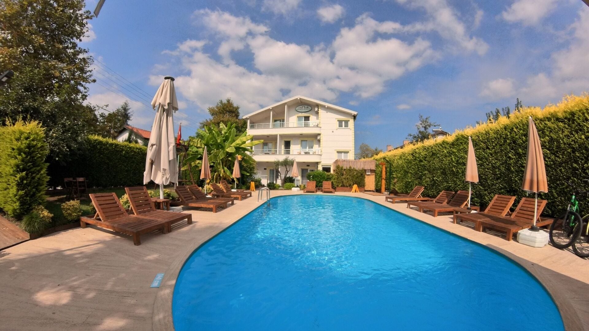 Outdoor pool, pool loungers, lifeguards on site