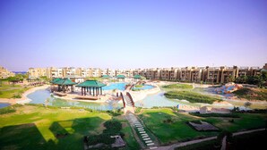 A resort with multiple swimming pools, a bridge, and a well-maintained lawn. - Blue Bay Asia Resort El Sokhna (Ataqah)