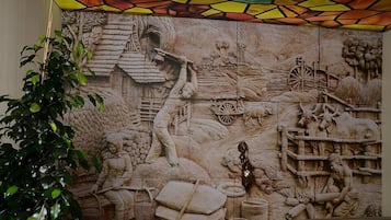 Un mural detallado que representa escenas agrícolas con figuras y maquinaria de granja.