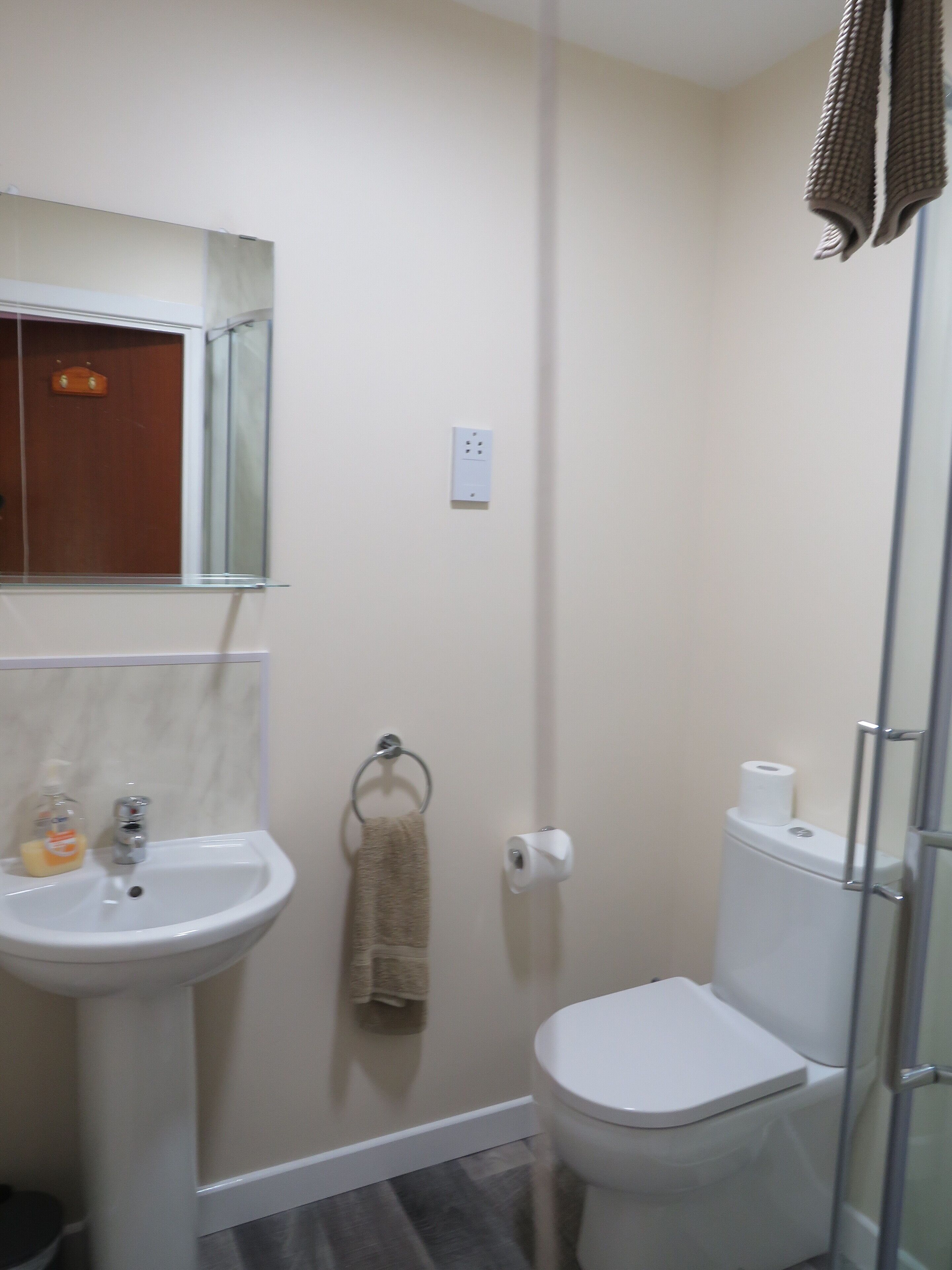 A bathroom with a sink, toilet, and shower.