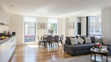 Deluxe Two Bedroom Apartment with Balcony | Living area | Flat-screen TV