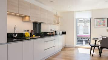 Deluxe Two Bedroom Apartment with Balcony | Private kitchen | Full-size fridge, microwave, oven, stovetop