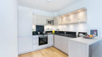 Deluxe One Bedroom Apartment with Balcony | Private kitchen | Full-sized fridge, microwave, oven, stovetop