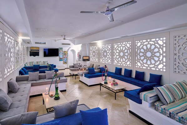 A modern living room with a sofa set, a coffee table, and a TV.