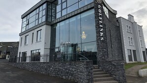 A modern building with large glass windows and a stone facade. - Golflinks Hotel (Portrush)