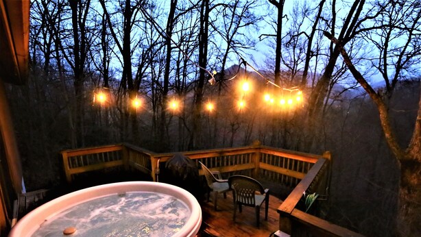 A hot tub on a wooden deck with a view of a forested area. - Beautifully Wooded & Serene Setting (Hot Tub) (Maggie Valley)