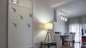 A modern living room with a dining area, a lamp, and wall art. - Exceptional Penthouse near Acropolis Museum by GHH (Athens)