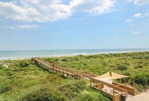A wooden boardwalk leading to a beach with a grassy area and a wooden structure with a canopy. - Large 1BD, 1BA Ocean Front Complex, Ground Floor, Free Wifi, Hdtv, Large pool (St Augustine)