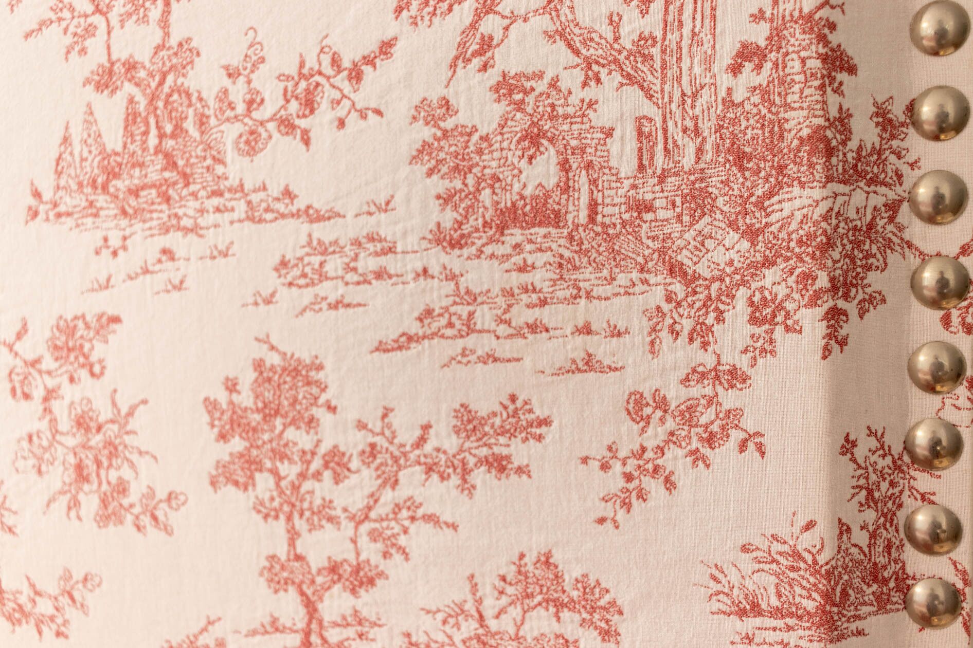 A fabric with a red floral pattern.