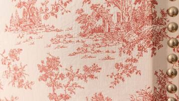 A fabric with a red floral pattern.
