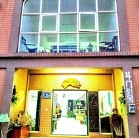 A building with a large window and a yellow entrance.