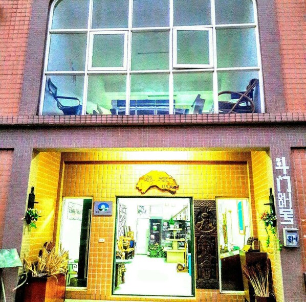 A building with a large window and a yellow entrance.