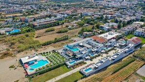 An aerial view of a resort with multiple buildings, a large swimming pool, and landscaped areas. - Blue oyster Beachfront villa, No car needed 6 (Rethymno)