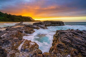 A coastal landscape with rocky formations and a sunset. - Amazing View ~ Amazing Price ~ Amazing Location (Princeville)