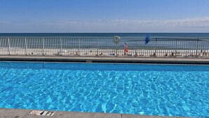 A swimming pool with a clear blue water surface, a lifeguard tower, and a beach in the background. - MILLION DOLLAR VIEW WITH PRIVATE PARKING SLEEPS 6, BOOK 7 DAYS GET 10% DISCOUNT! (Pensacola)