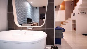A modern bathroom with a large oval sink, a mirror, and a staircase leading to another level. - STAY GONGDAM  (Changwon)