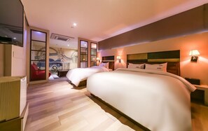 A modern hotel room with a large bed, two bedside tables with lamps, a red chair, and a wall mural. - STAY GONGDAM  (Changwon)
