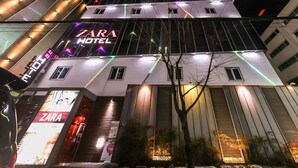 A multi-story building with a Zara Hotel sign, featuring a modern architectural design with large windows and a prominent entrance. - STAY GONGDAM  (Changwon)