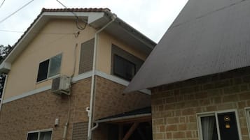 A two-story building with a brick facade and a flat roof.