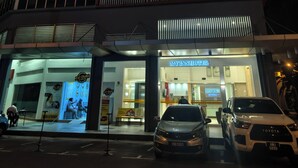 A multi-story hotel with a prominent 'MY INN HOTEL' sign, large windows, and a visible entrance. - My Inn Hotel Kota Samarahan (Kota Samarahan)