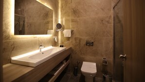 A modern bathroom with a large sink, mirror, and shower. - Hotel Excellence Inn (Ankara)
