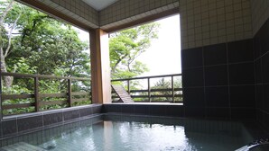 A hot spring area with tiled walls and a wooden railing. - Hotel&Resort Mashio (Oshima)
