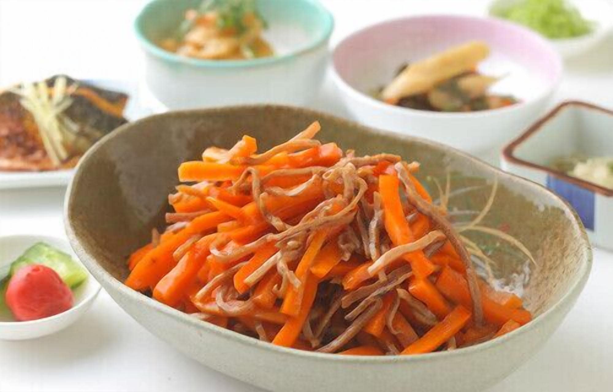 A bowl of sliced carrots and onions.