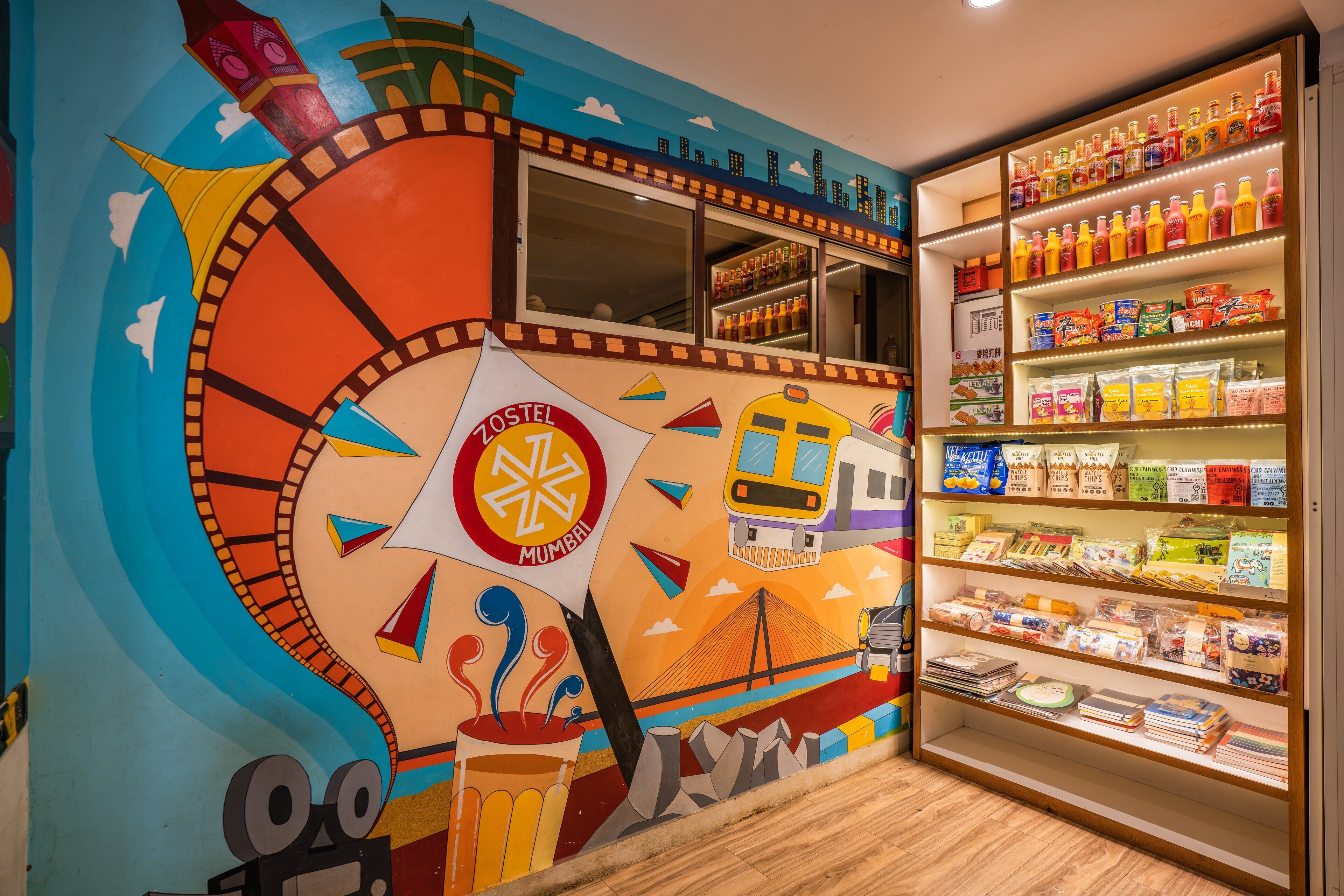 A colorful mural with a film reel design, a clock tower, and a train.