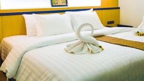 A hotel room with a bed, pillows, a wall-mounted picture, and a light fixture. - The Route Sriracha Hotel And Residence (Si Racha)
