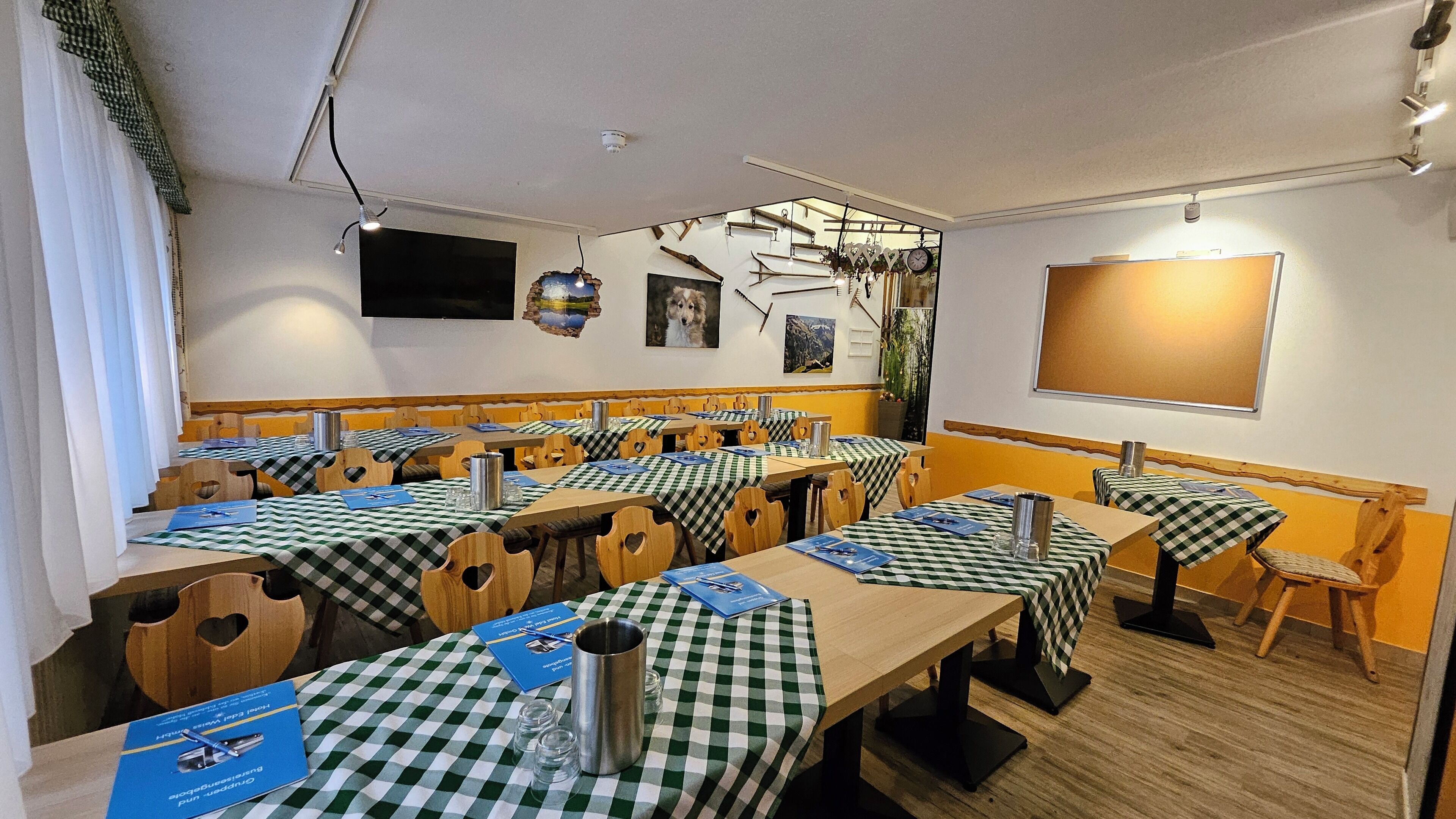 A dining area with multiple tables, each covered with a checkered tablecloth, and wooden chairs with heart-shaped cutouts.