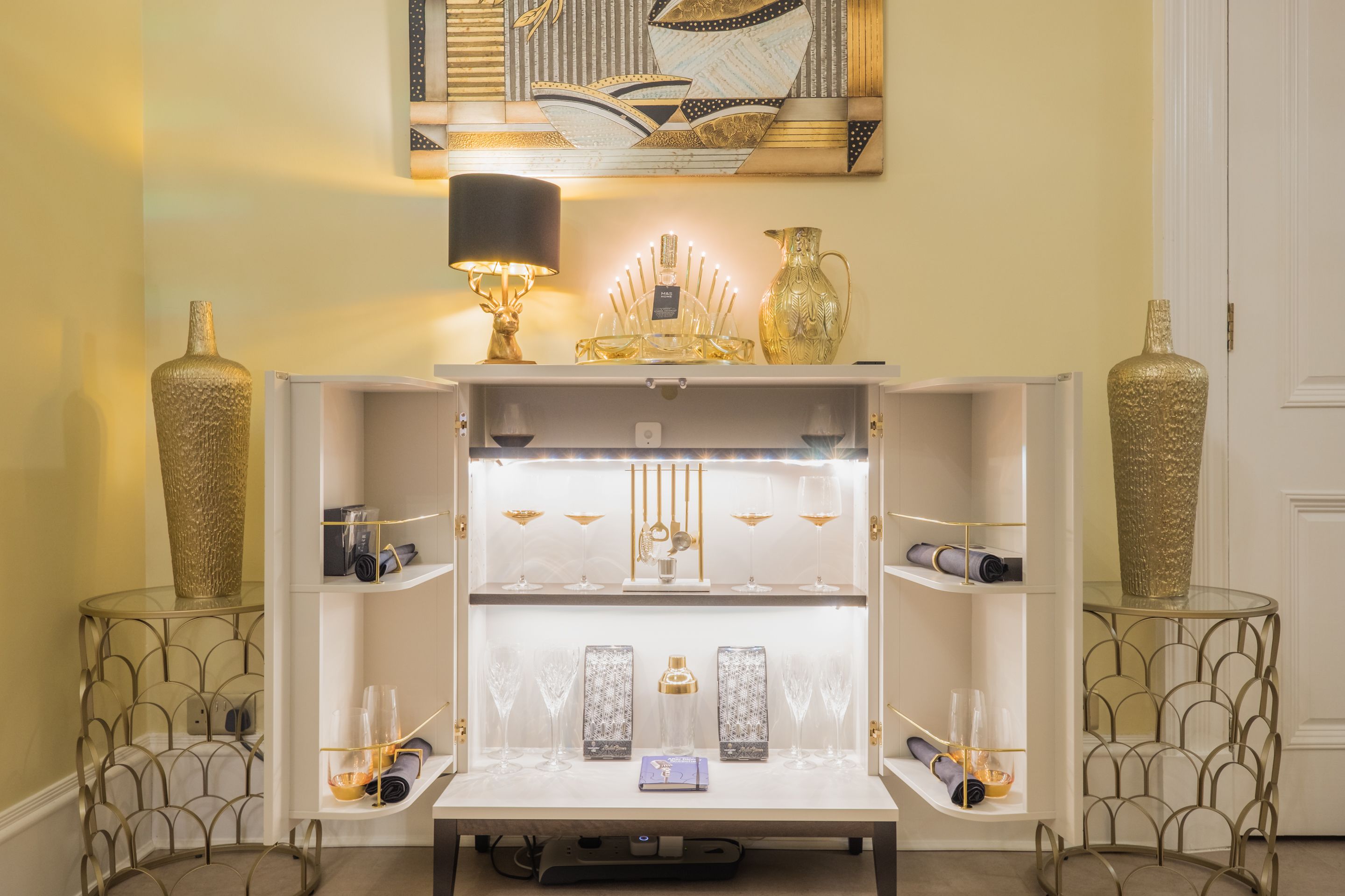 A well-lit display area with shelves holding various decorative items and glassware.