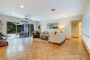 Living area with large slider doors that lead to pool