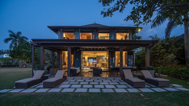 A modern house with a covered patio area, outdoor seating, and a well-maintained lawn. - Luxury Oceanfront Villa w/Breathtaking Views! Infinity Edge Pool! (Llandovery, Laughlands)