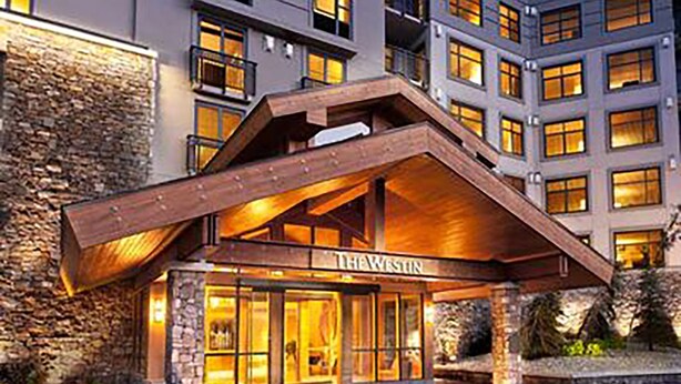 A hotel entrance with a stone facade, wooden overhang, and a sign reading "THE WESTIN". - Monache, Mammoth Village, Luxury Studio (Mammoth Lakes)
