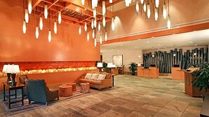 A spacious lobby with a large seating area, a reception desk, and a wall with vertical light fixtures. - Monache, Mammoth Village, Luxury Studio (Mammoth Lakes)