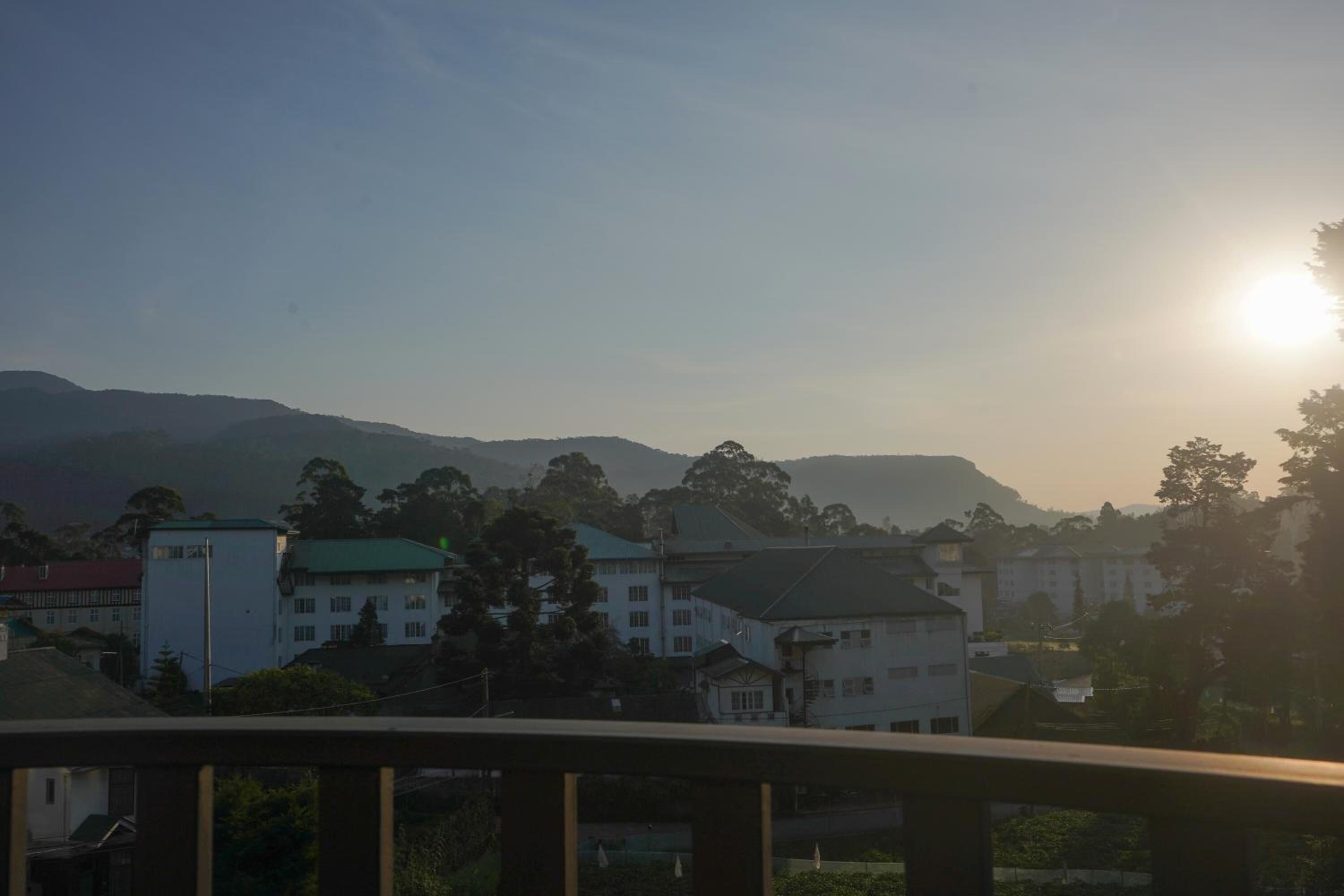 A residential area with houses and a mountain in the background.