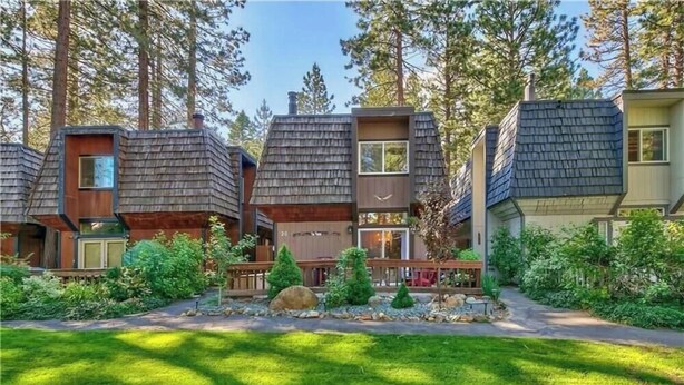 A row of modern, multi-story houses with sloped roofs, surrounded by lush greenery and tall trees. - 3 Bedroom Incline Village Retreat Next to Championship Golf Course (IVGID)