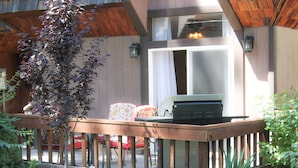 A wooden deck with outdoor furniture, a grill, and a small garden area with rocks and plants. - 3 Bedroom Incline Village Retreat Next to Championship Golf Course (IVGID)