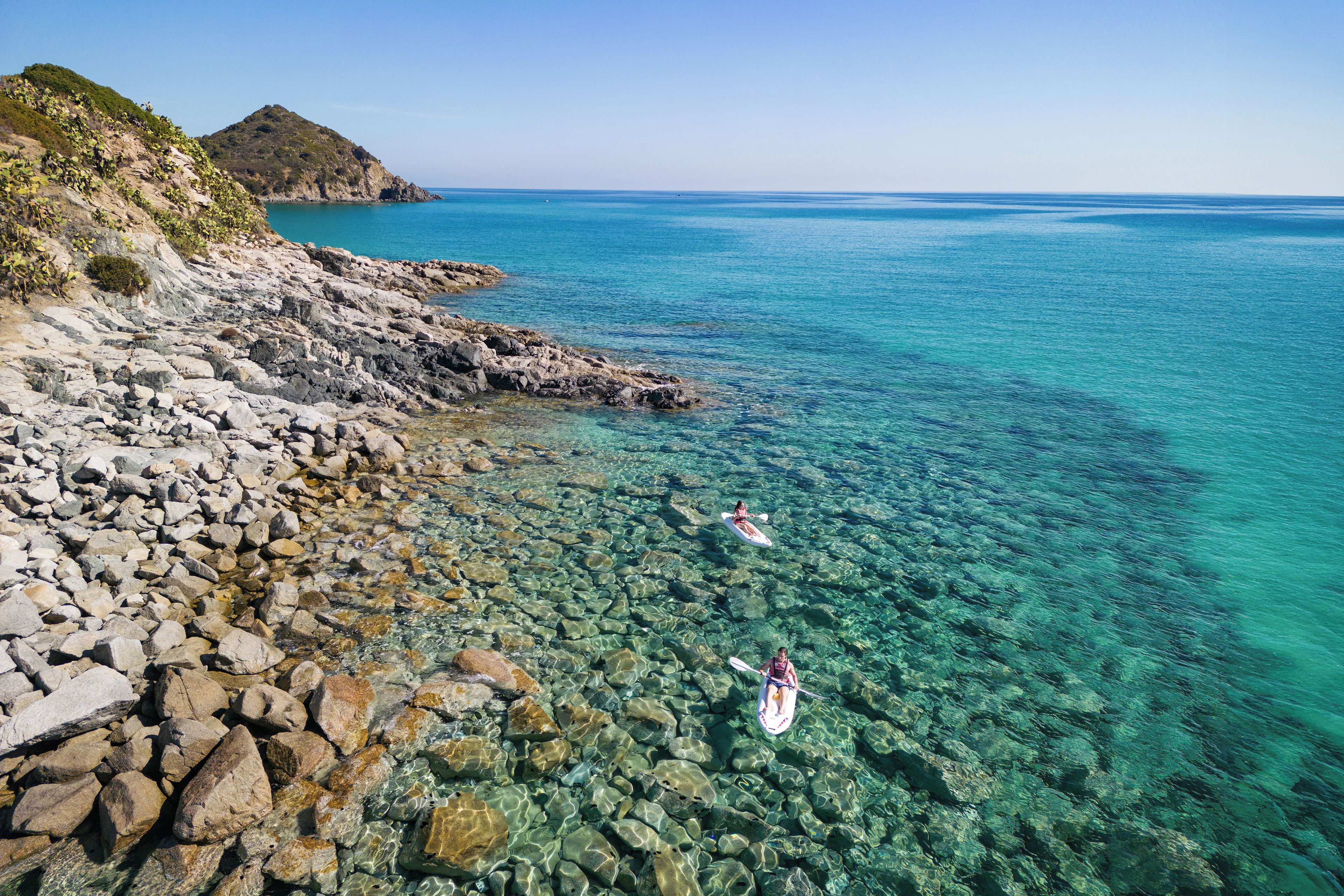 A rocky shoreline with clear turquoise water.