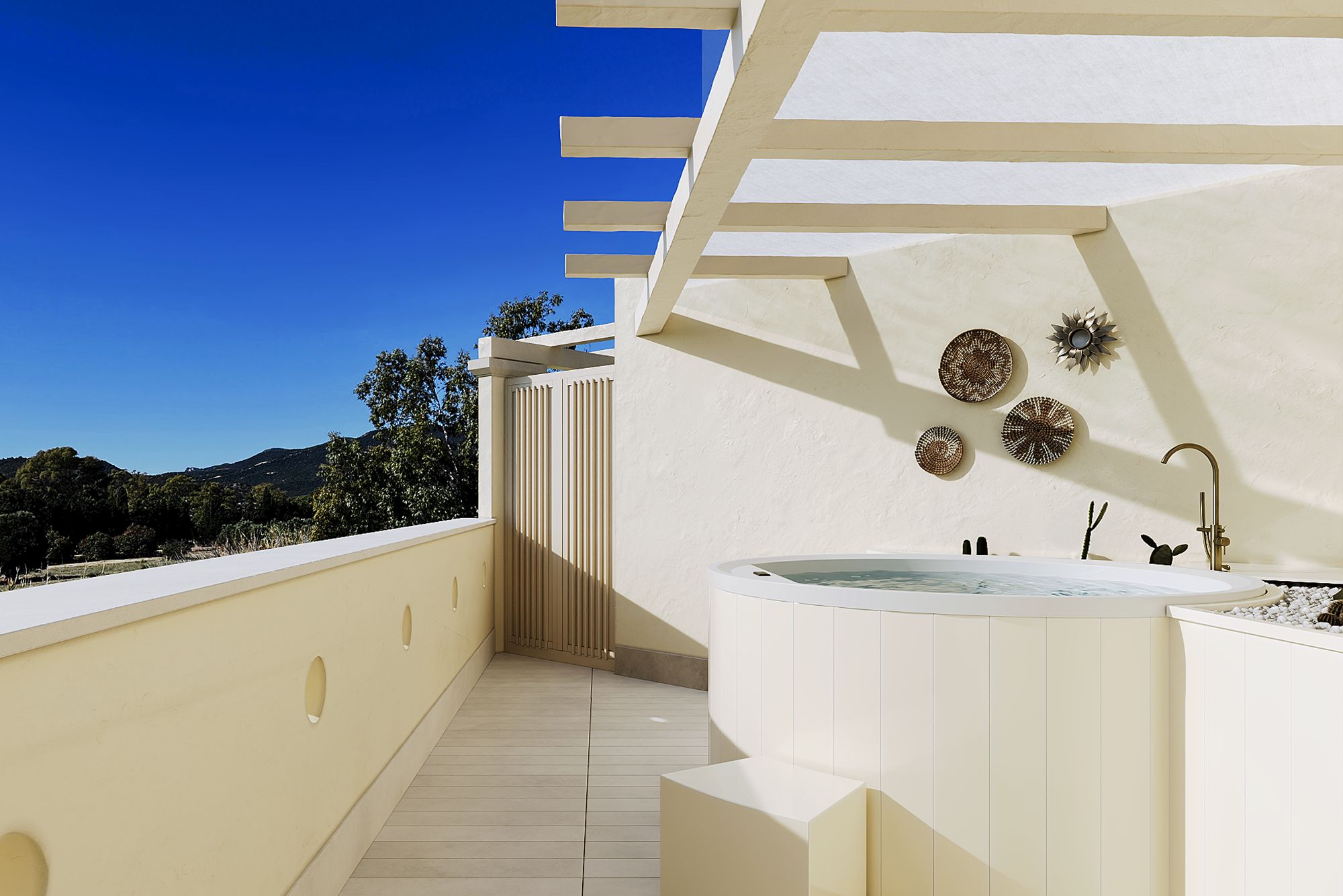 A modern bathroom with a freestanding bathtub, a sink, and decorative plates on the wall.