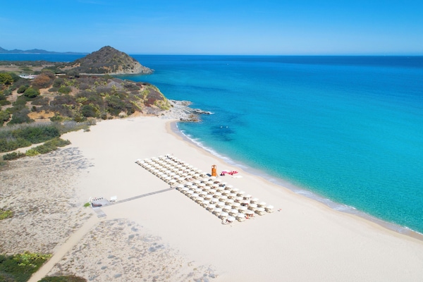 On the beach, white sand, sun-loungers, beach umbrellas