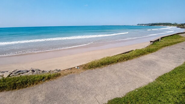 A coastal beach with a concrete walkway along the shore. - Villa Yuvin (Dondra)