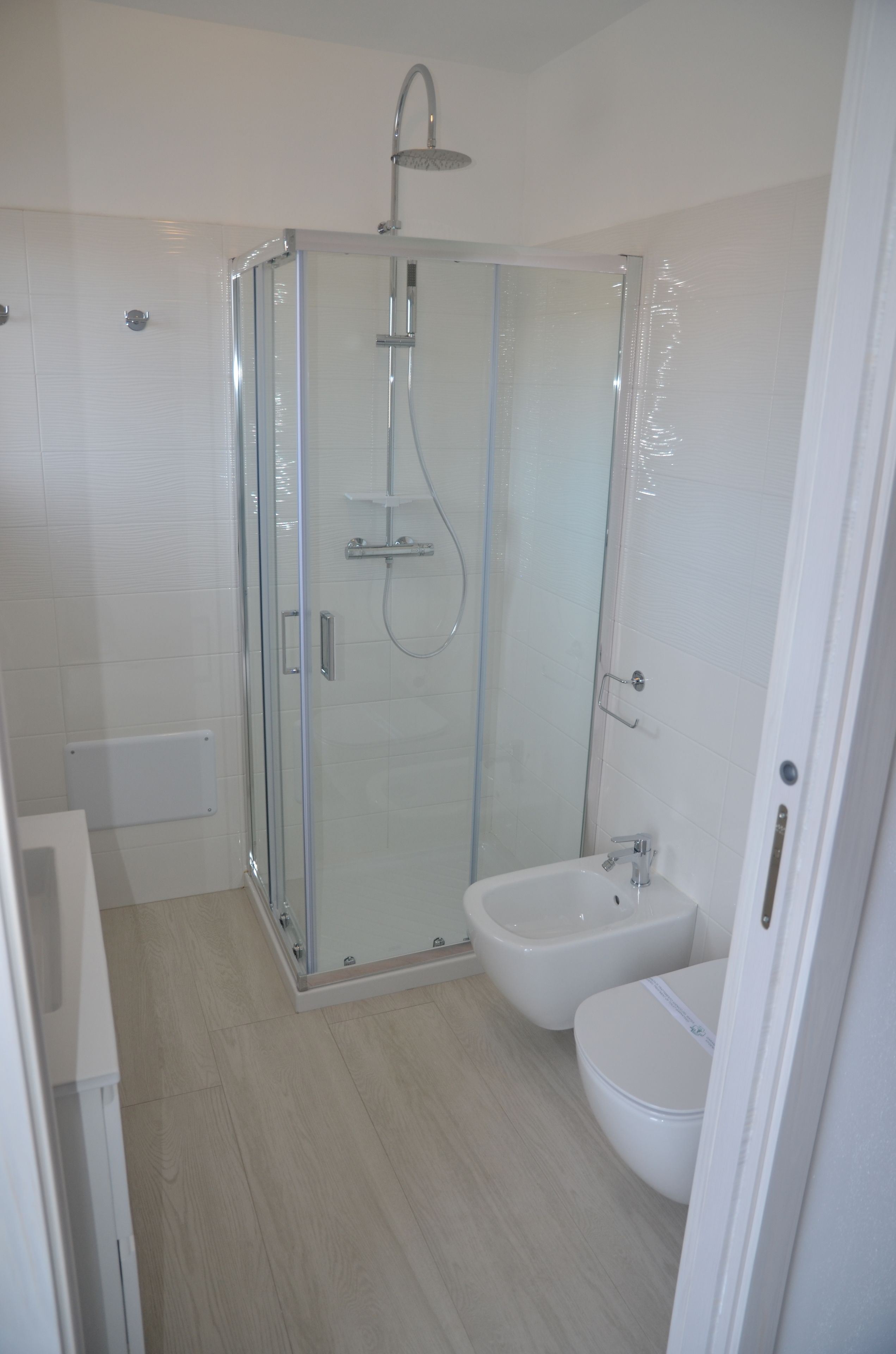 Une salle de bain moderne dotée d’une douche à parois de verre, d’un bidet et de toilettes.