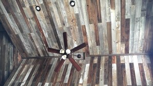 A ceiling with a wooden panel design and a central ceiling fan. - Welcome to our Rock Creek Fortress of Solitude. (Philipsburg)